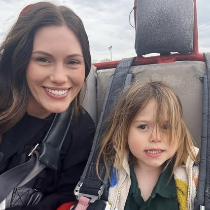 A woman and a young child are sitting together in car seats, smiling at the camera after a fun day riding Go Karts at Boschertown Go Karts in St. Charles. The child has long, light brown hair and wears a green shirt and light jacket.